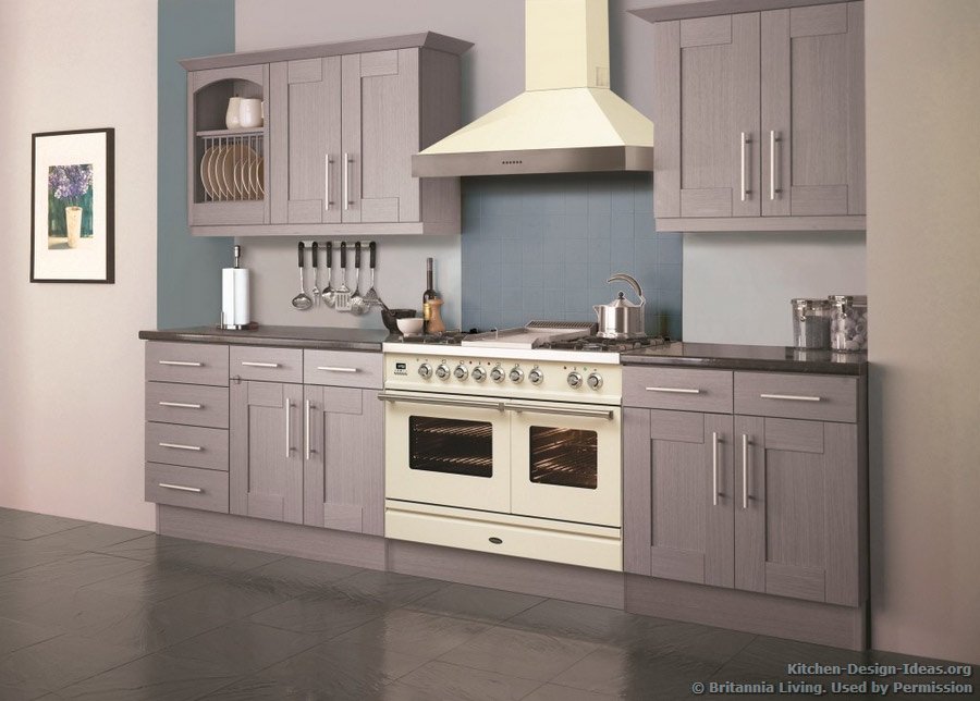 A soft lavender kitchen with a cream-colored range oven and hood