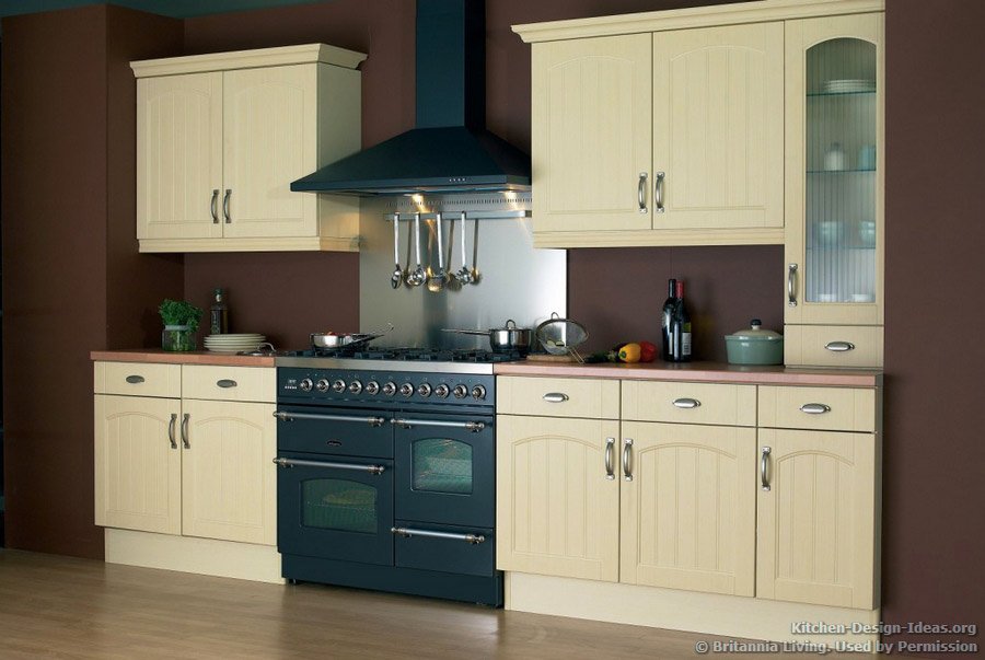 A butter yellow kitchen with a graphite black double oven range