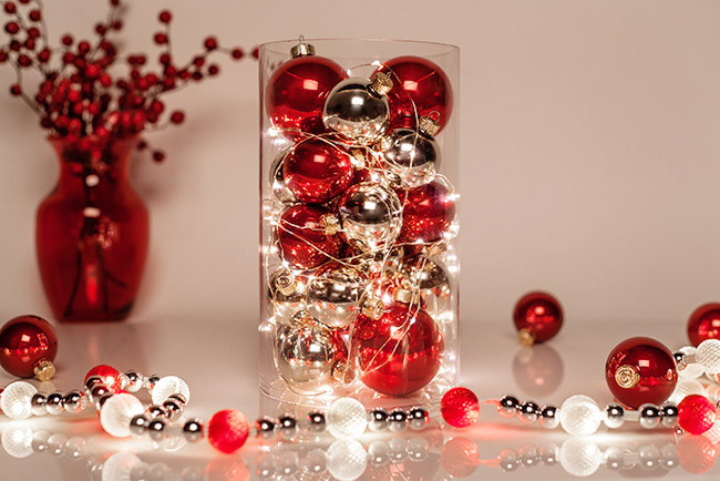 Create a glowing centerpiece for Christmas dinner using ornaments and fairy string lights! 