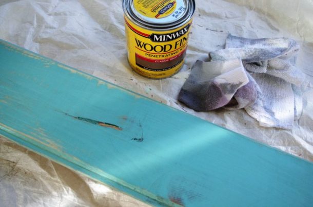 DIY Family Word Art Sign Woodworking Project Tutorial Turquoise Board Stained after Sanding to add subtle weathered look