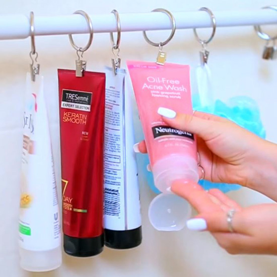 DIY Tips for an Organized Bathroom - Shower Hack - Use a Tension Rod and Rings with clips to keep your shampoo and body washes up off of the floor and easily accessible #bathroomorganization #bathroomideas #bathroomhacks #bathroomtips #organizethebathroom