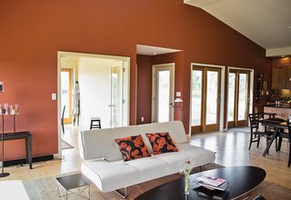 Sofa Bed Versus Wall Bed: What's Best For Your Small Space? - Photo 3 of 10 - In this great room, a Splendor sofa bed by Innovation, an Eames Wire Base Elliptical table, and an Eames Wire Base Low table sit atop a Tufenkian rug from Dover Rug &amp; Home near a #11 dining table by Skovby.