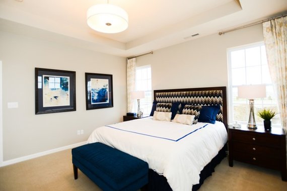 earth-toned bedroom wall with bed