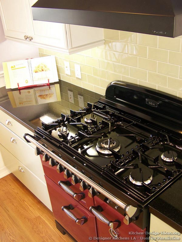 A Glossy Red AGA Range Oven with a Black Cooktop and Classic Styling