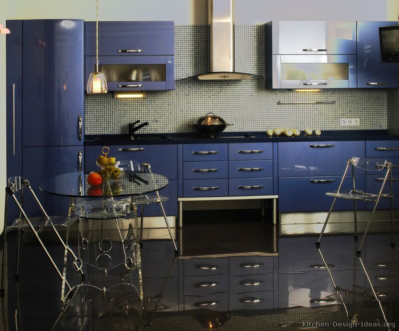 A luxurious modern design with glossy blue kitchen cabinets and metallic accents.