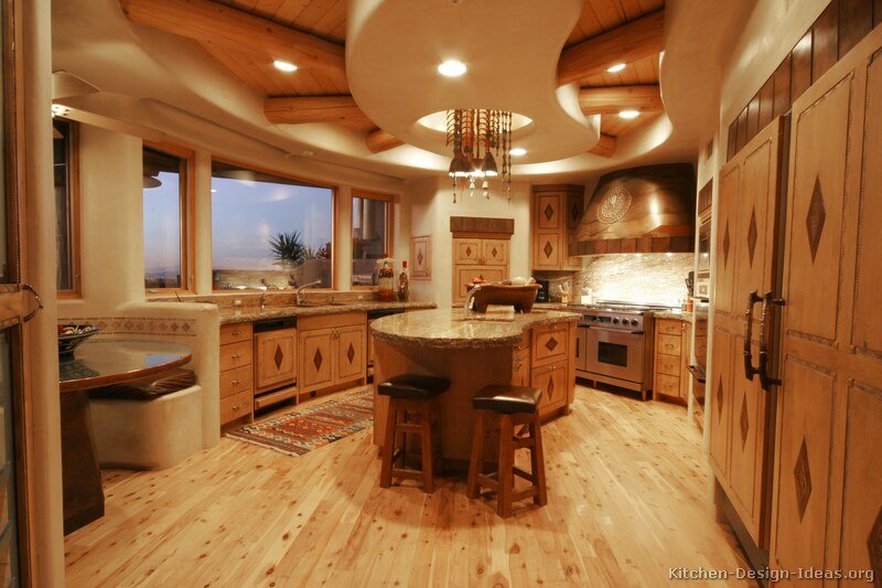 Rustic Santa Fe Style Kitchen with Adobe Walls, Inlaid Cabinets, and Log Ceiling Beams