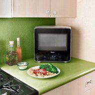 This mini Whirlpool microwave (WMC20005YD) has an oval-shaped back for fitting into a corner.