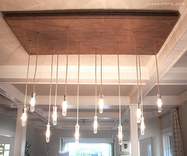DIY Industrial Edison Style Chandelier: This awesome chandelier is made from a recycled coffee table or cabinet door. It add a rustic warm to your home.