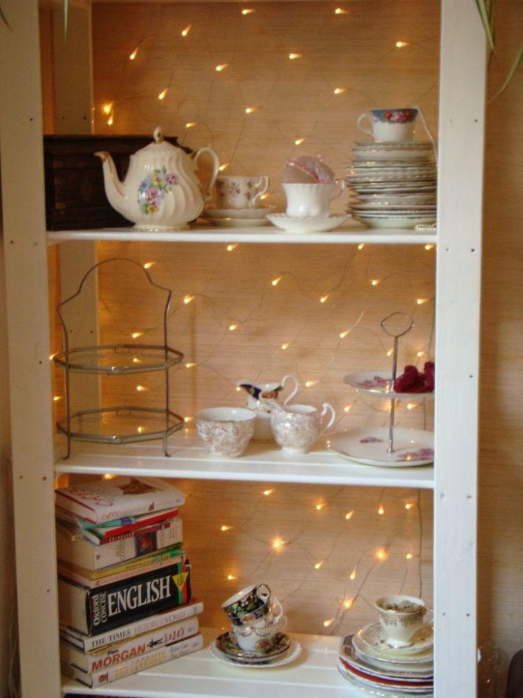 Shelves backed with fairy lights.