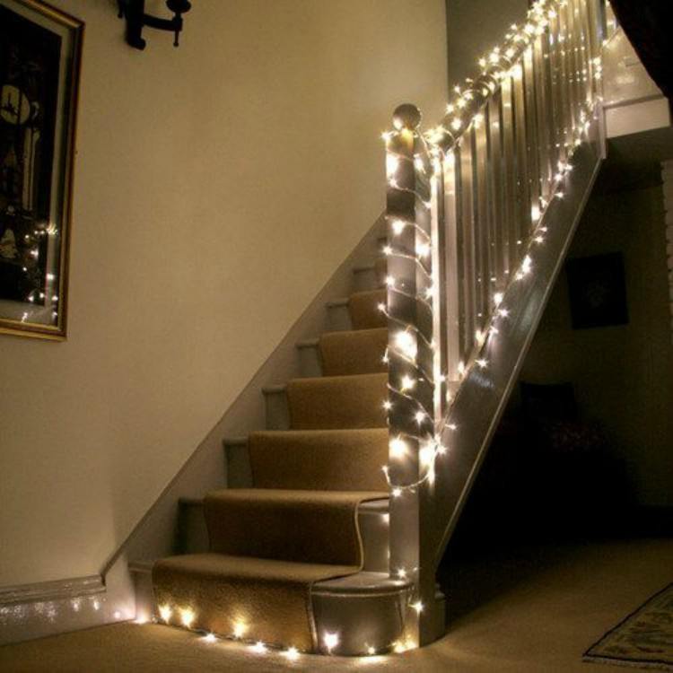 Stairs draped in fairy lights.