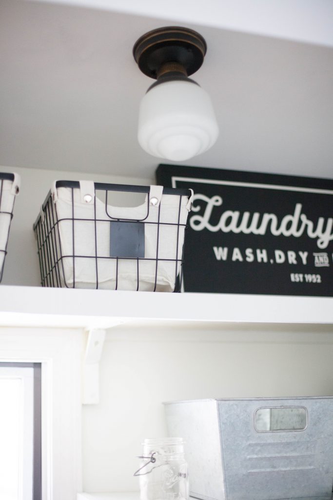 A budget-friendly farmhouse laundry room that's small, yet makes a large impact. The space is not only pretty, but functional for your laundry needs!