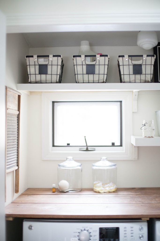 A budget-friendly farmhouse laundry room that's small, yet makes a large impact. The space is not only pretty, but functional for your laundry needs!