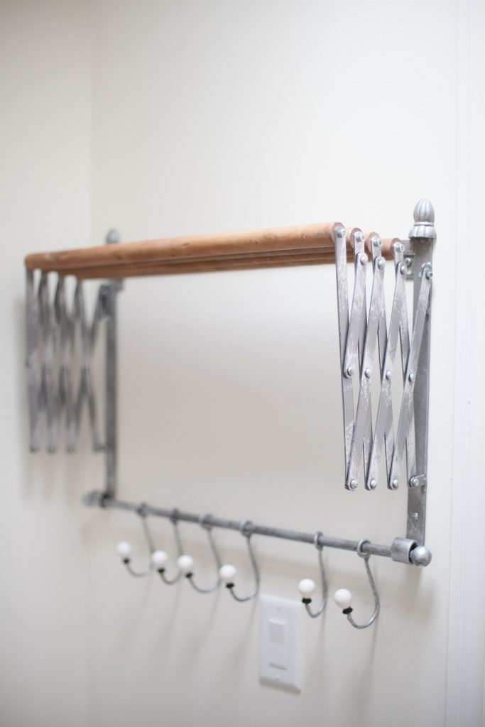 This accordion wall drying rack is fun and functional for your farmhouse laundry room!