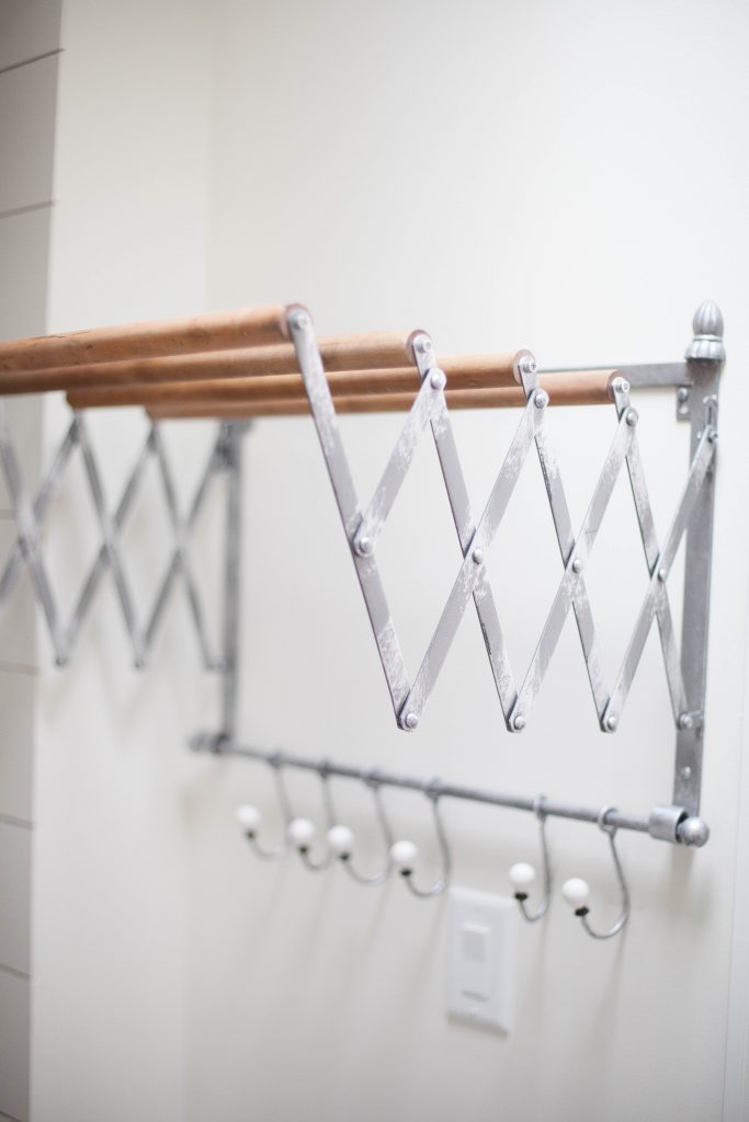 This accordion wall drying rack is fun and functional for your farmhouse laundry room!