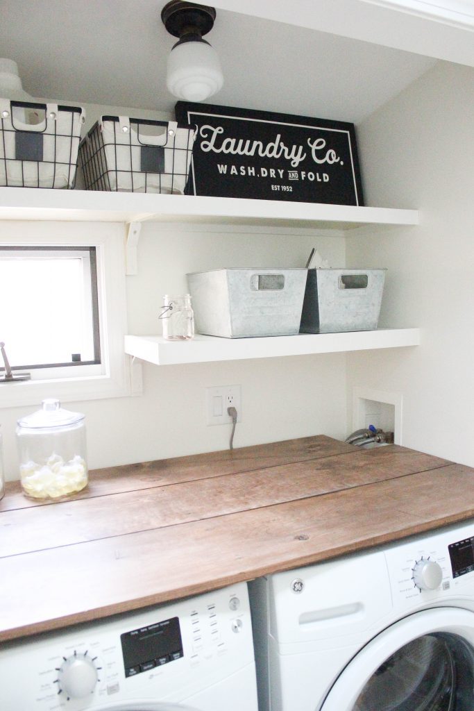 A budget-friendly farmhouse laundry room that's small, yet makes a large impact. The space is not only pretty, but functional for your laundry needs!