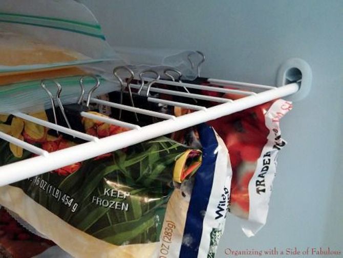 Clip opened bags underneath a shelf for a super organized freezer
