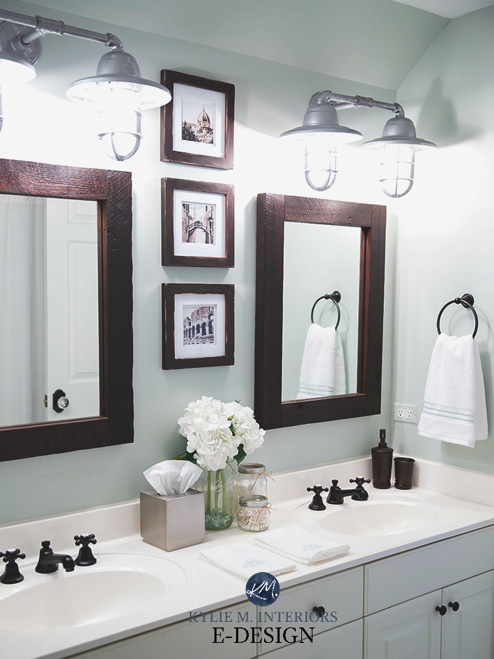 Sherwin Williams Sea Salt in a bathroom with white countertop, vanity, farmhouse bulbs, wood framed mirror. Kylie M E-design, online color consultant