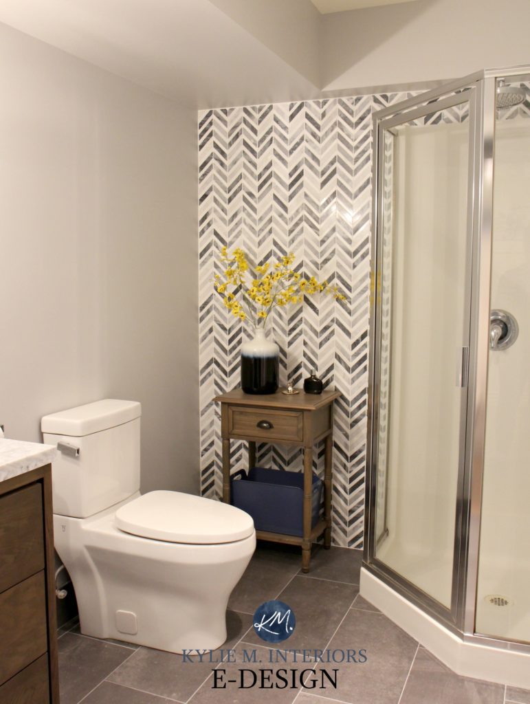 herringbone or chevron gray marble accent tile in small bathroom with corner shower feature wall. Kylie M interiors E-design